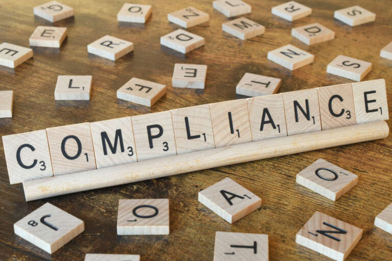 wooden-letter-tiles-spelling-out-the-word-complian-2026-01-08-22-22-04-utc